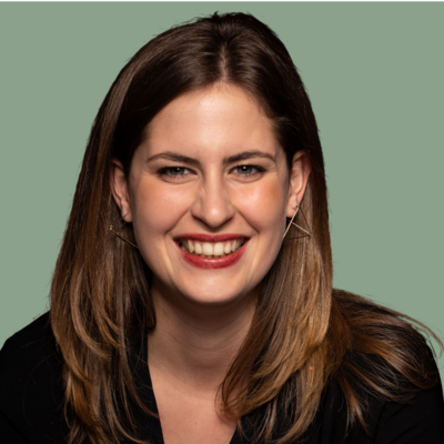 Frau mit schwarzer Bluse vor grünem Hintergrund