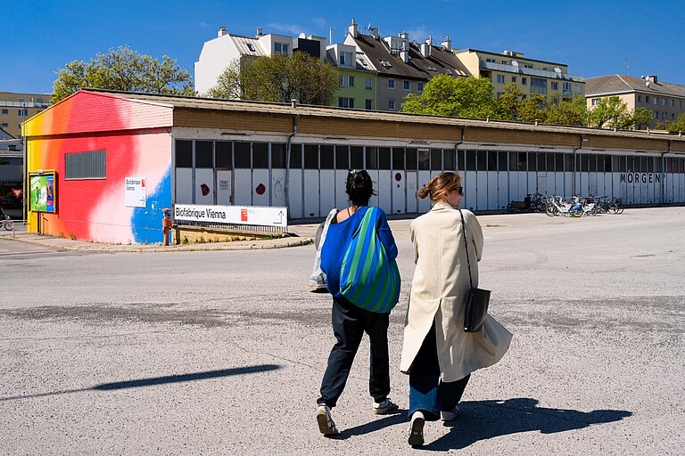 Open House Nordwestbahnhof Shade Commons Zwei Personen gehen auf das Areal des Nordwestbahnhof
