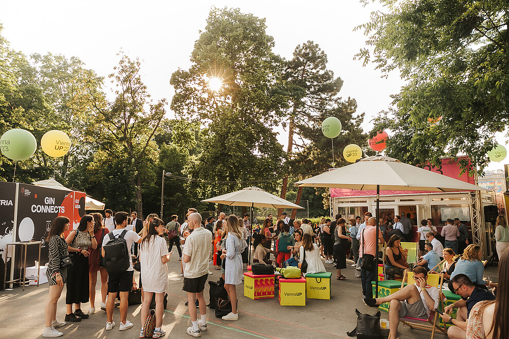 A photo of many people chatting and network at ViennaUP's open-air festival Homebase.