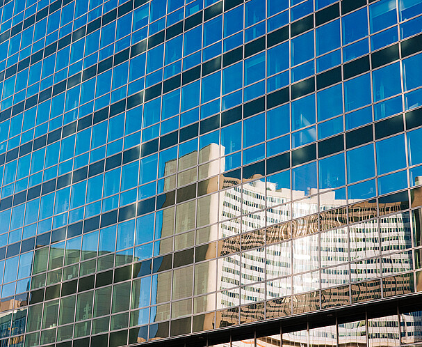 Reflection in a glass facade of a building of the UN building in Vienna 